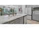 Kitchen island with a sink overlooking the living and dining areas at 12871 Cinqueterre Dr, Venice, FL 34293