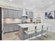 Modern kitchen with a center island, stylish countertops and stainless appliances at 12871 Cinqueterre Dr, Venice, FL 34293