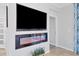 Cozy living room with a modern electric fireplace and large wall-mounted television at 12871 Cinqueterre Dr, Venice, FL 34293