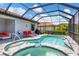 Beautiful pool and spa area within a screened lanai, complete with loungers for ultimate relaxation at 12871 Cinqueterre Dr, Venice, FL 34293
