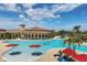 The community's large resort style pool is surrounded by lounge chairs and tropical landscaping at 12871 Cinqueterre Dr, Venice, FL 34293
