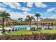 The community's resort-style pool area features ample seating, palm trees, and well-manicured landscaping at 12871 Cinqueterre Dr, Venice, FL 34293