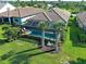 This aerial view captures a private screened pool, and beautiful landscaping in a desirable neighborhood at 13016 Rinella St, Venice, FL 34293