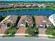 Aerial view of the community highlighting a lake and well-maintained homes with mature landscaping at 13016 Rinella St, Venice, FL 34293