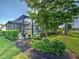 Beautiful backyard with a screened-in lanai, pool, lush landscaping, and a tranquil garden statue at 13016 Rinella St, Venice, FL 34293