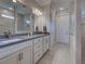 Bathroom featuring double sinks, granite countertops, and a large mirror at 13016 Rinella St, Venice, FL 34293
