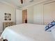 Serene bedroom featuring white linens, decorative pillows, and ample closet space at 13016 Rinella St, Venice, FL 34293