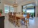 Comfortable dining area with an eight person table and sliding glass doors to the lanai at 13016 Rinella St, Venice, FL 34293
