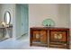 Hallway featuring neutral walls with trim and decorative rustic chest at 13016 Rinella St, Venice, FL 34293