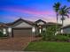 Charming single-story home boasts a well-manicured lawn and a two-car garage with a brick paved driveway at 13016 Rinella St, Venice, FL 34293