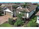 An elevated view of this single-story home shows the manicured lawn and brick paver driveway at 13016 Rinella St, Venice, FL 34293
