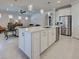 Bright, open kitchen featuring a large island, stainless steel appliances, and pendant lighting at 13016 Rinella St, Venice, FL 34293
