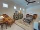 Cozy living room with unique furniture and a ceiling fan at 13016 Rinella St, Venice, FL 34293