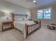 Well-lit main bedroom with a large window and neutral decor at 13016 Rinella St, Venice, FL 34293