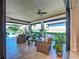 Inviting covered patio featuring comfortable seating and lush greenery, perfect for enjoying serene water views at 13016 Rinella St, Venice, FL 34293