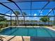Sparkling swimming pool with views of a serene lake under a clear, blue sky at 13016 Rinella St, Venice, FL 34293