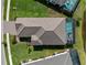 An aerial view shows a home with a backyard pool, well-manicured landscaping, and a brick driveway at 13056 Steinhatchee Loop, Venice, FL 34293