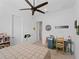 Bedroom with light wood flooring, ceiling fan, and a desk area for studying at 13056 Steinhatchee Loop, Venice, FL 34293