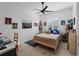 Bright bedroom with light wood flooring, fan, and decorated with super hero themes at 13056 Steinhatchee Loop, Venice, FL 34293