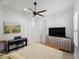 Bright bedroom with a ceiling fan, flatscreen television, and piano for added entertainment at 13056 Steinhatchee Loop, Venice, FL 34293