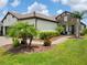 Beautiful single-story home featuring manicured landscaping and a stone-accented entryway at 13056 Steinhatchee Loop, Venice, FL 34293