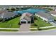 Beautiful home with a paved driveway, two-car garage, and well-maintained landscaping, with a lake view at 13056 Steinhatchee Loop, Venice, FL 34293
