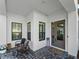 Charming front porch with comfortable seating, decorative accents, and a welcoming entrance at 13056 Steinhatchee Loop, Venice, FL 34293