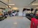 Large garage with an epoxy floor includes a refrigerator and lots of room for storage at 13056 Steinhatchee Loop, Venice, FL 34293