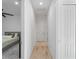 Hallway with light colored wood look floors leading to bedroom at 13056 Steinhatchee Loop, Venice, FL 34293
