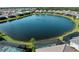 Overhead image capturing the lake with backyard pools surrounded by screened enclosures of nearby residences at 13056 Steinhatchee Loop, Venice, FL 34293