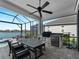 Outdoor kitchen with seating area overlooks the pool and lake at 13056 Steinhatchee Loop, Venice, FL 34293