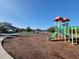 Community playground with slides and playground equipment on a mulched surface at 13056 Steinhatchee Loop, Venice, FL 34293