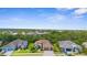 Aerial view of a beautiful home surrounded by lush greenery and neighborhood homes at 13280 Campanile Ct, Venice, FL 34293