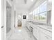 Elegant bathroom with marble floors, double vanities, and glass-enclosed shower at 13280 Campanile Ct, Venice, FL 34293