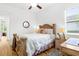 Cozy bedroom with carved wood bed frame, side tables, and natural light from a window at 13280 Campanile Ct, Venice, FL 34293