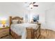 Bedroom with ornamental bed frame, side tables, plush pillows and great natural light at 13280 Campanile Ct, Venice, FL 34293