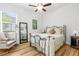 Cozy bedroom with decorative metal bed frame, wood floors, and large window at 13280 Campanile Ct, Venice, FL 34293