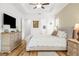 Large bedroom with light-colored walls, wood floors, and decorative touches at 13280 Campanile Ct, Venice, FL 34293