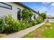Charming exterior of home with lush landscaping and brick walkway at 13280 Campanile Ct, Venice, FL 34293