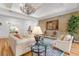 Sophisticated living room with a decorative painting, hardwood floors, and ample seating at 13280 Campanile Ct, Venice, FL 34293