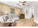 Inviting living room featuring damask wallpaper, comfortable seating and a serene view from french doors at 13280 Campanile Ct, Venice, FL 34293