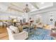 Open living room boasts a chandelier, hardwood floors, and access to the kitchen at 13280 Campanile Ct, Venice, FL 34293