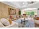 Elegant living room with brick accent wall, hardwood floors, and stylish seating at 13280 Campanile Ct, Venice, FL 34293