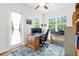 Office space with two monitors, desk, bright natural light, light colored floor and ceiling fan at 13280 Campanile Ct, Venice, FL 34293