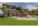 Community playground with slides and other activities, set in a lush green space at 13280 Campanile Ct, Venice, FL 34293