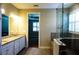 Granite countertops accent the vanity in the primary bathroom with a walk-in shower and large window at 136 Positano Trl, Nokomis, FL 34275