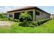 Single-story home boasts a tile roof, stucco walls, manicured landscaping, and a screened-in lanai at 136 Positano Trl, Nokomis, FL 34275