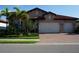 Charming home featuring a red tile roof, two-car garage, well-maintained landscaping and a brick driveway at 136 Positano Trl, Nokomis, FL 34275