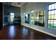 Fitness center featuring weights, mirrors, wood flooring and windows at 136 Positano Trl, Nokomis, FL 34275