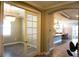 Bright foyer leading to a modern kitchen with a large island and breakfast nook, adjacent to a living area at 136 Positano Trl, Nokomis, FL 34275